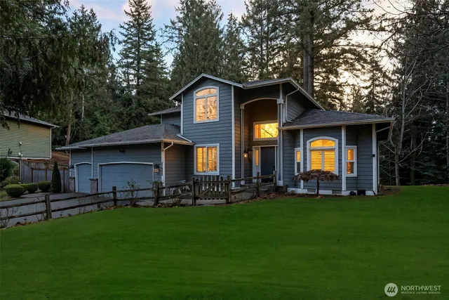 a front view of house with yard and green space
