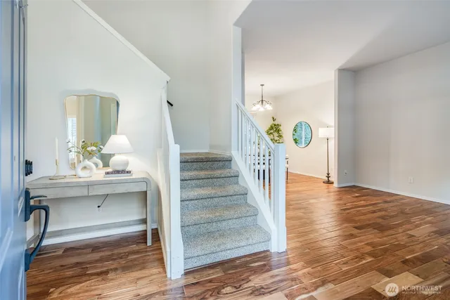 a view of entryway and hall with wooden floor