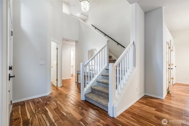a view of entryway and hall with wooden floor