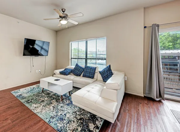 a living room with couches and a flat screen tv