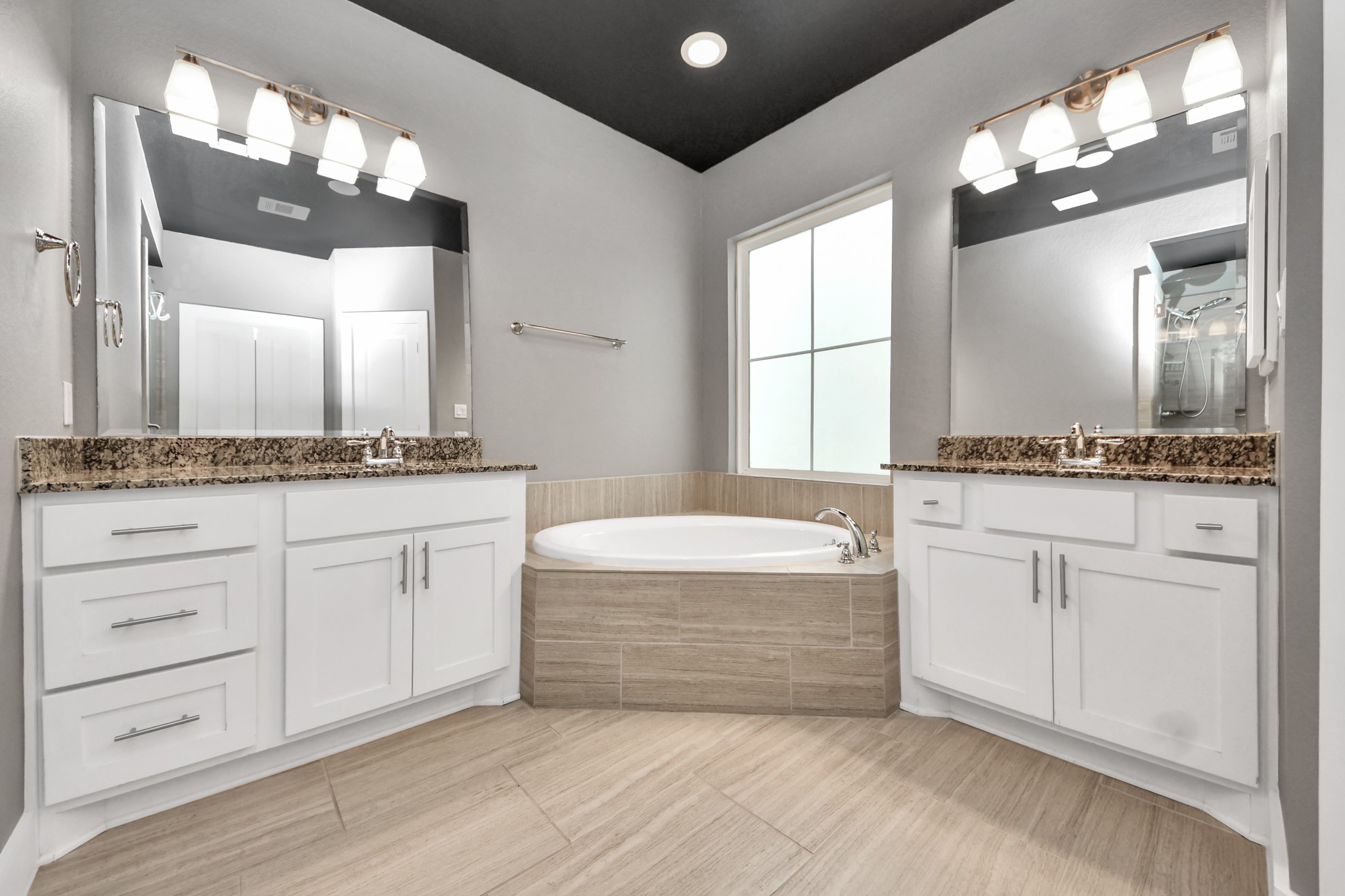 2704 Freund Street Houston, TX 77003 - Photo 32 of 45 a spacious bathroom with a granite countertop sink and a mirror