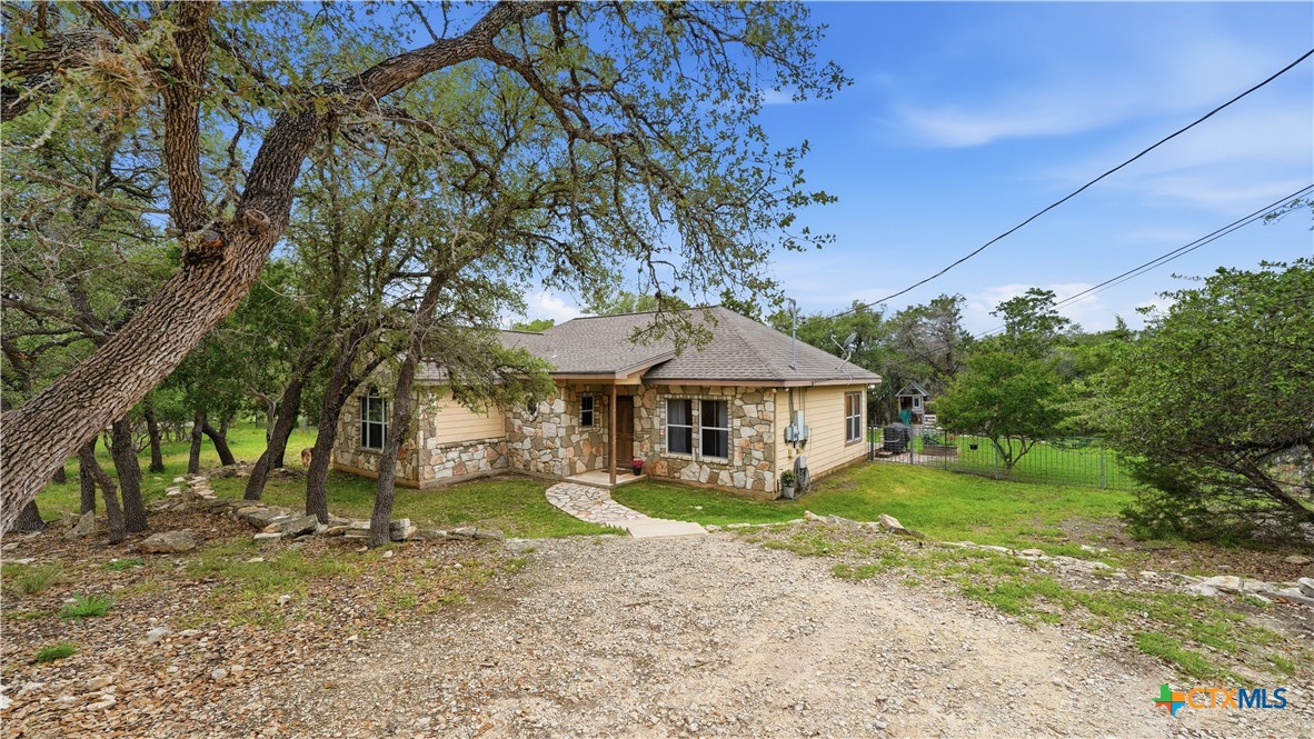 2216 Hornsby Spring Branch, TX 78070 - Photo 28 of 33 a view of a house with a yard and large tree