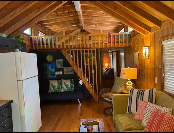 a dining room with furniture and a refrigerator