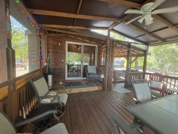 a view of a porch with furniture and a yard