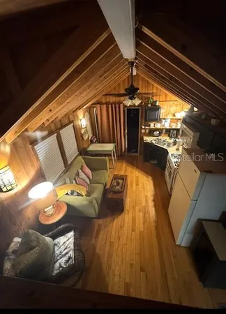 a view of a living room with wooden floor