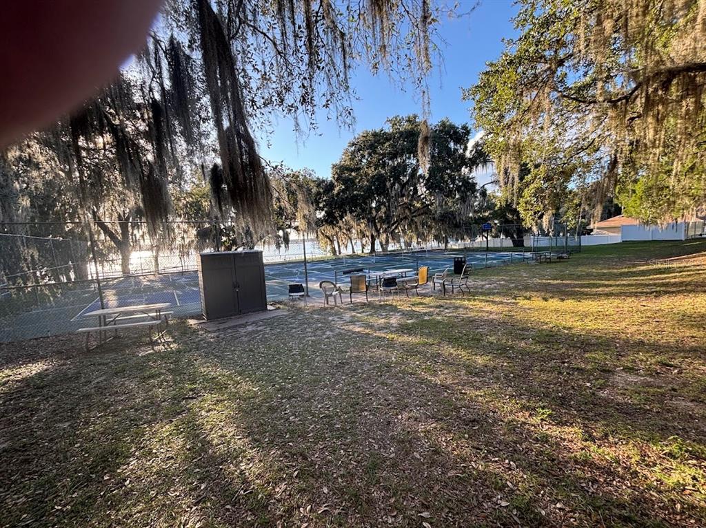 25235 142nd Lane Northeast, Unit 185 Fort McCoy, FL 32134 - Photo 33 of 49 a view of outdoor space with garden and trees