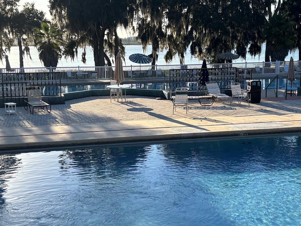 25235 142nd Lane Northeast, Unit 185 Fort McCoy, FL 32134 - Photo 42 of 49 a view of a swimming pool with an outdoor space