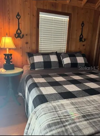 a bedroom with a bed and a lamp