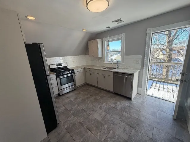a kitchen with sink cabinets and window