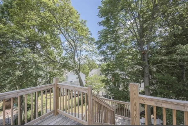 a view of a wooden deck and trees