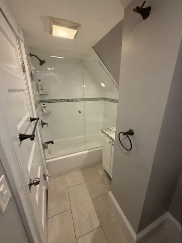 a bathroom with a bathtub and shower