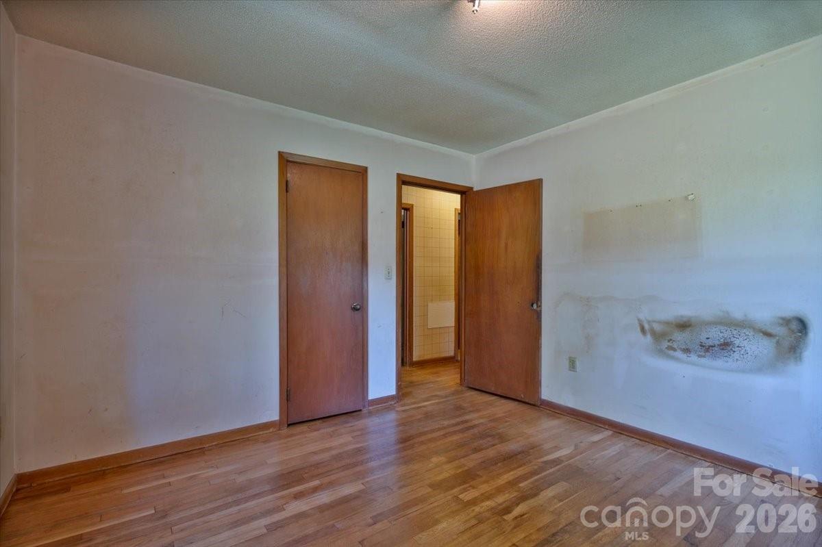156 Old Sweetwater Road Robbinsville, NC 28771 - Photo 19 of 25 a view of an empty room with wooden floor and closet