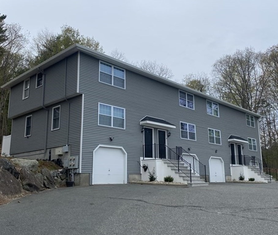 104 Walpole Street, Unit 6 Canton, MA 02021 - Photo 1 of 1 a front view of a house with a garden and parking space