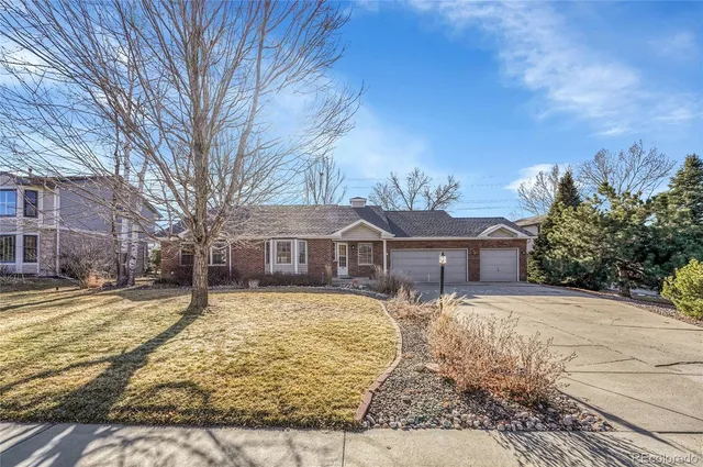a front view of a house with a yard covered in snow
