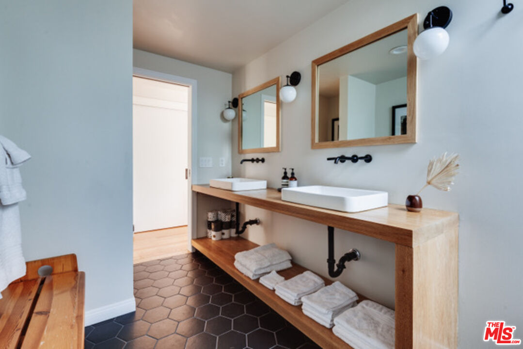 3629 Serra Road Malibu, CA 90265 - Photo 8 of 18 a bathroom with a sink mirror and a toilet