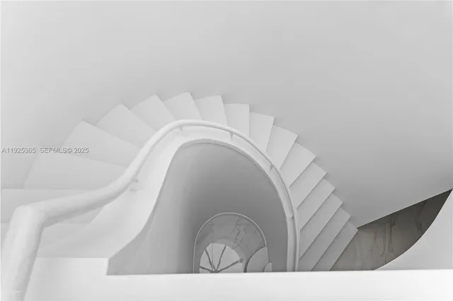 a view of staircase with white walls