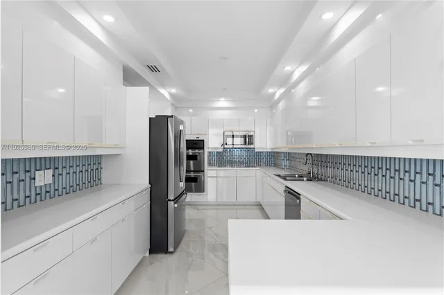 a kitchen with granite countertop white cabinets and white appliances