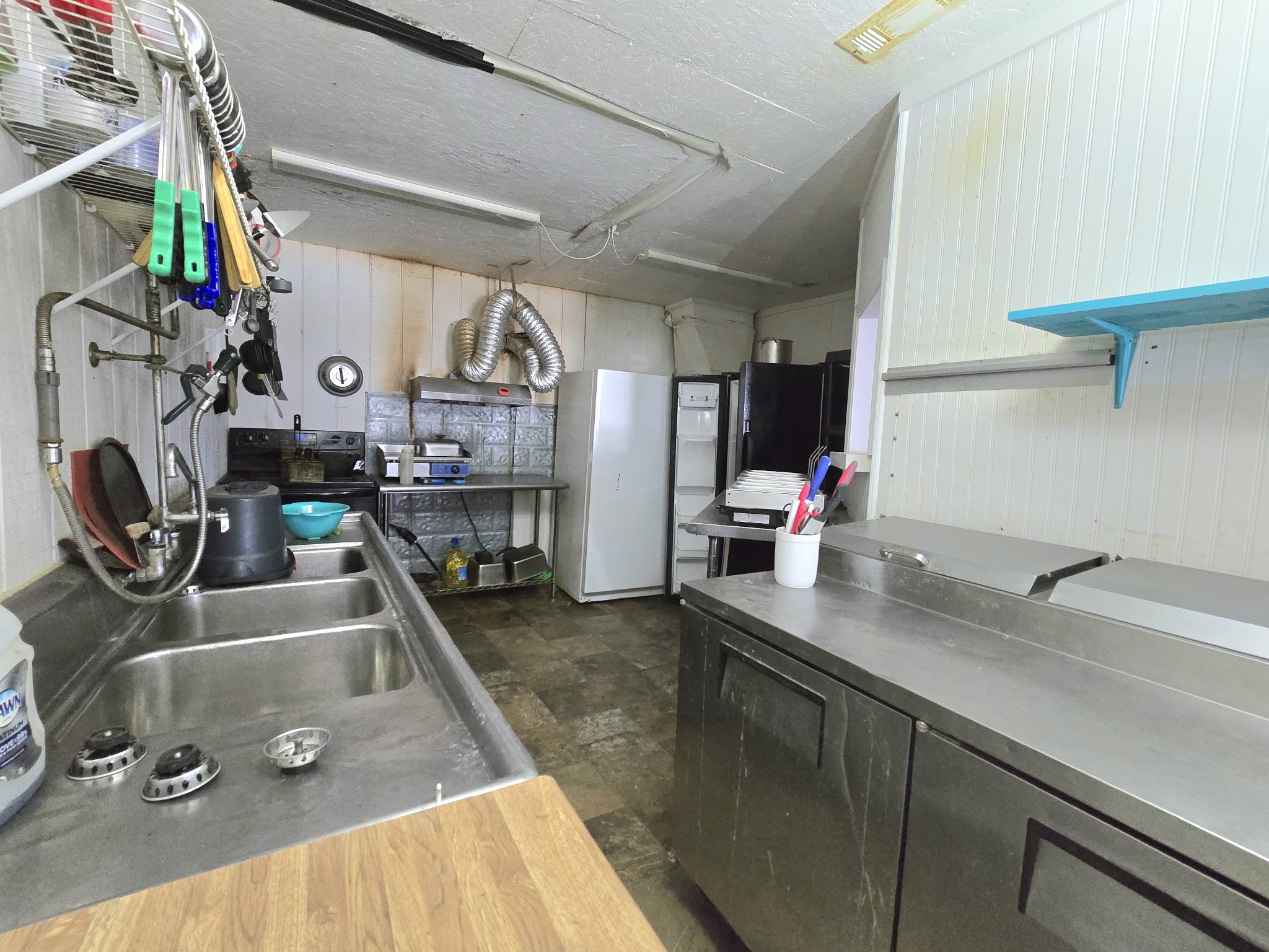 7089 Short Mountain Road McMinnville, TN 37110 - Photo 31 of 36 a kitchen with stainless steel appliances granite countertop a sink dishwasher and cabinets