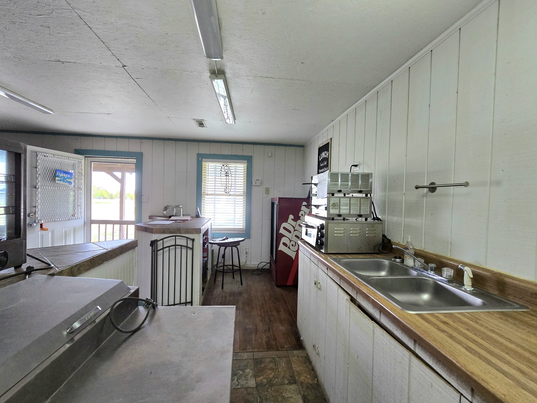 7089 Short Mountain Road McMinnville, TN 37110 - Photo 34 of 36 a kitchen with a sink stove and cabinets