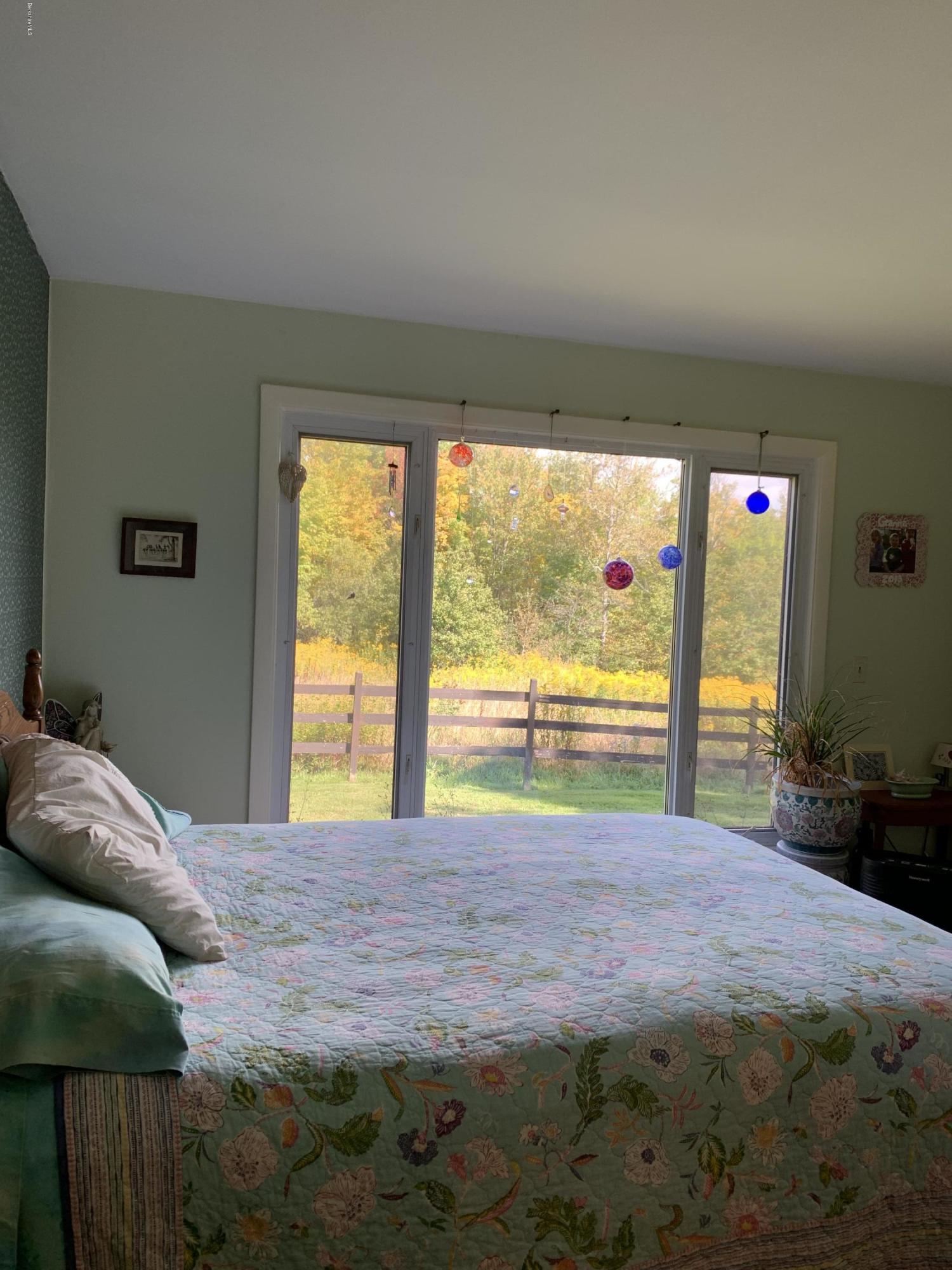 100 Jackson Road Savoy, MA 01256 - Photo 11 of 38 a bed sitting in a bedroom next to a window