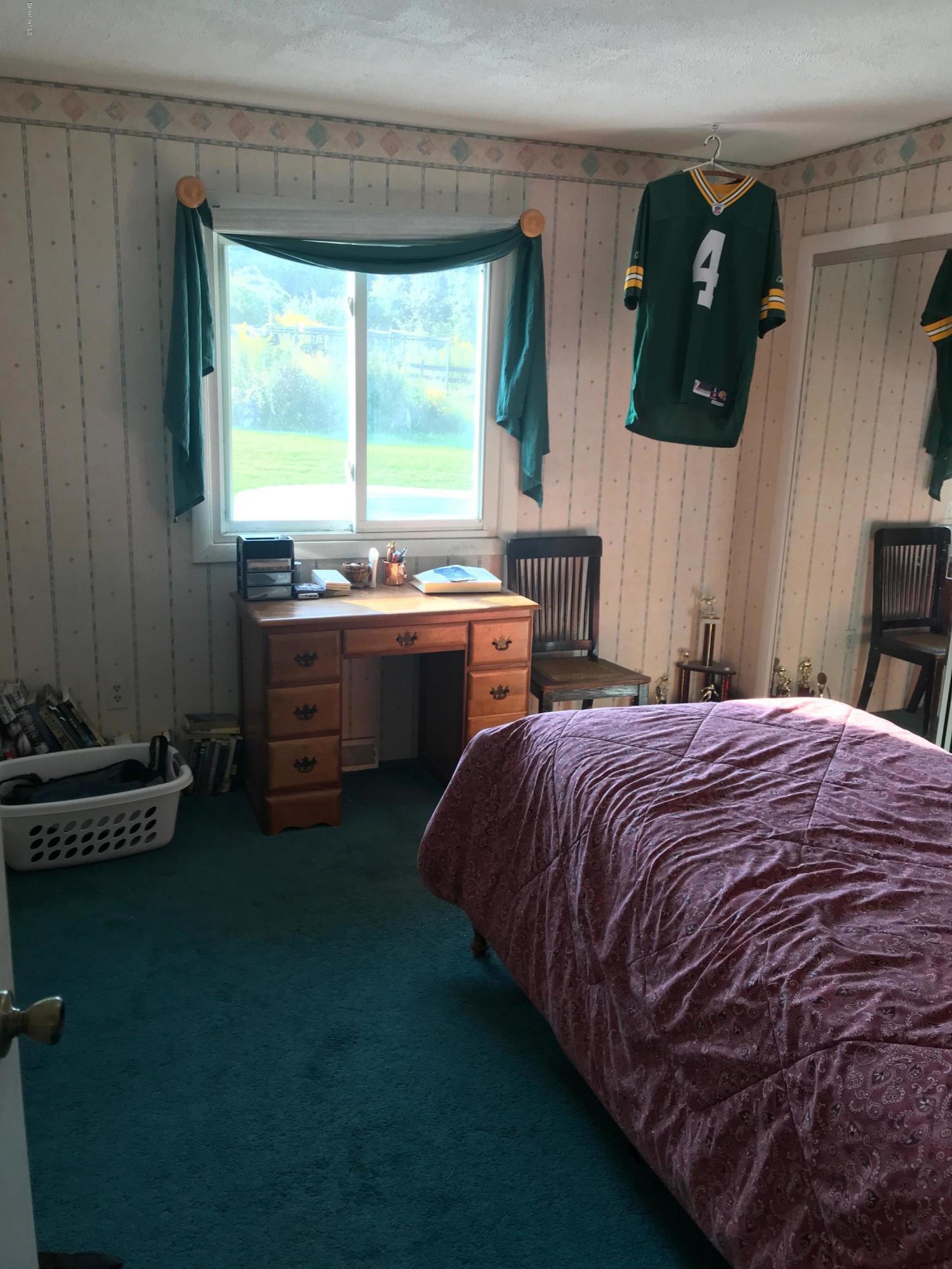 100 Jackson Road Savoy, MA 01256 - Photo 13 of 38 a bed sitting in a bedroom next to a window