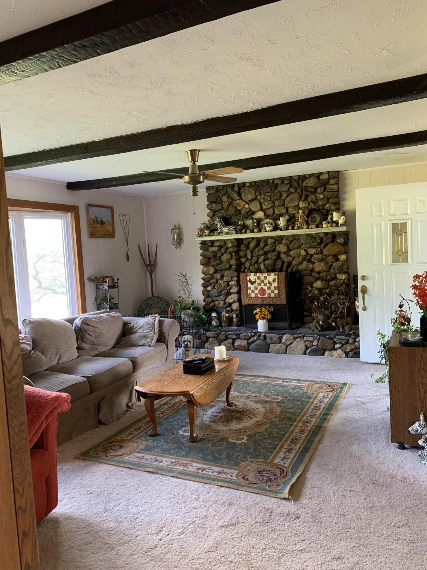 100 Jackson Road Savoy, MA 01256 - Photo 8 of 38 a living room with furniture a window and a fireplace