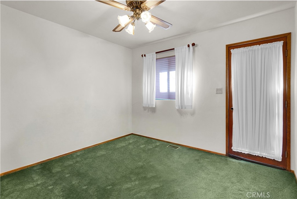 2471 Captains Walk Bradley, CA 93426 - Photo 16 of 42 an empty room with a chandelier fan and windows