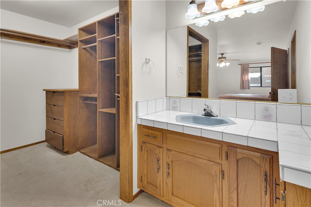 2471 Captains Walk Bradley, CA 93426 - Photo 21 of 42 a bathroom with a granite countertop sink mirror and double