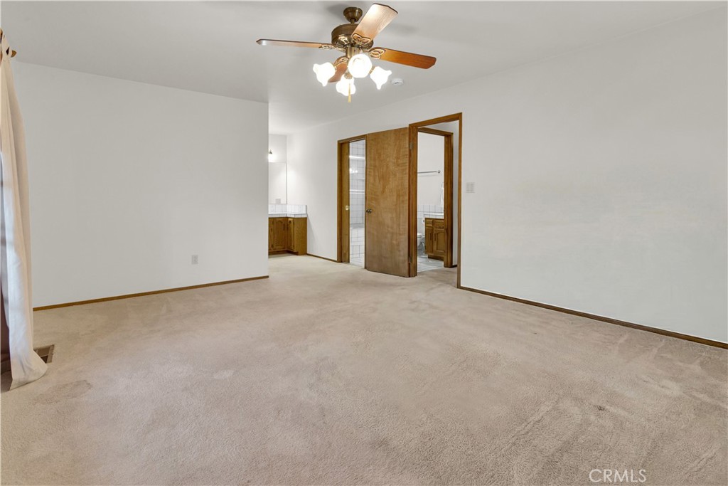 2471 Captains Walk Bradley, CA 93426 - Photo 23 of 42 a view of a big room with windows and chandelier fan
