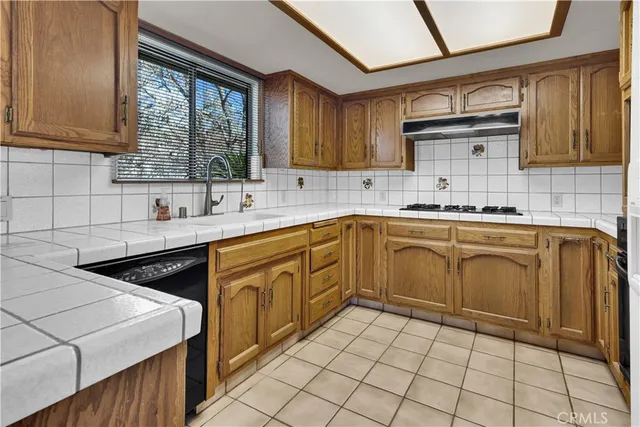 a kitchen with a sink stove and cabinets