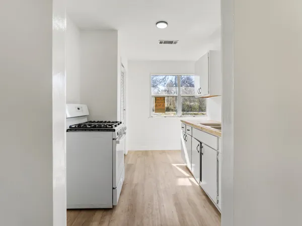 a kitchen with a refrigerator and a stove