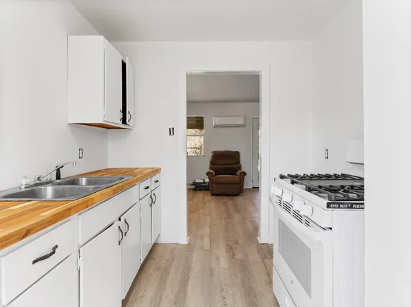 a kitchen with sink stove and cabinets
