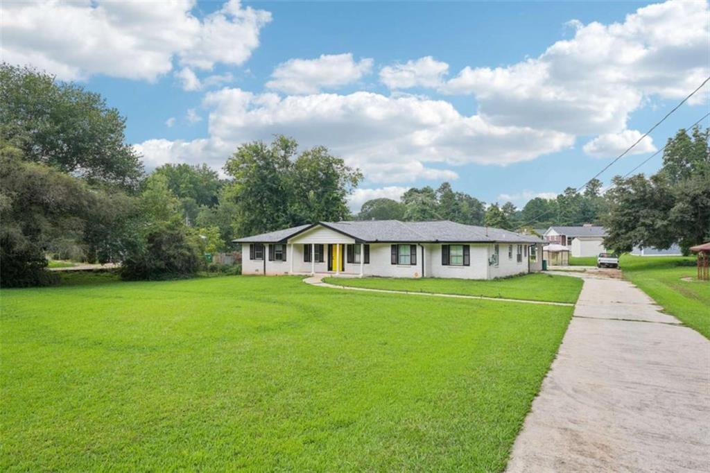 4134 Dunmore Road Decatur, GA 30034 - Photo 1 of 1 a view of a big house with a big yard and large trees