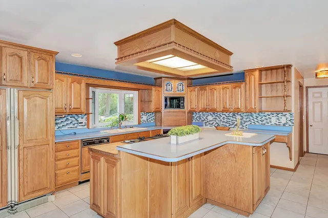 a view of empty room with wooden floor and fireplace