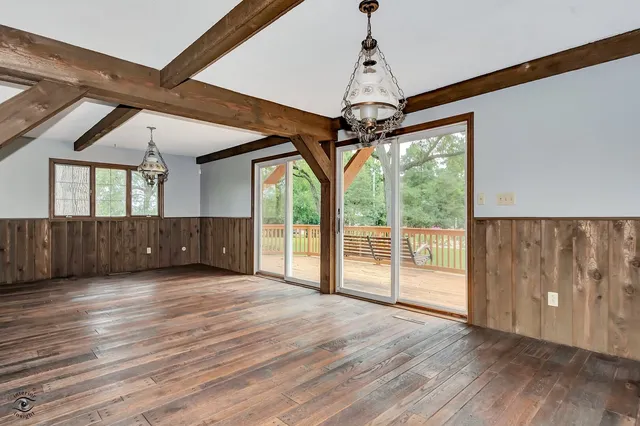a room with pool table and windows