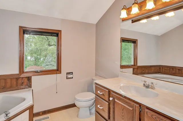 a bathroom with a sink mirror and a shower