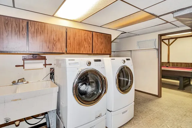 a view of a house with a big yard plants and large trees