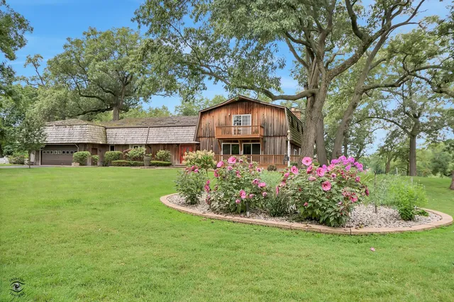 a view of a house with a yard and sitting area