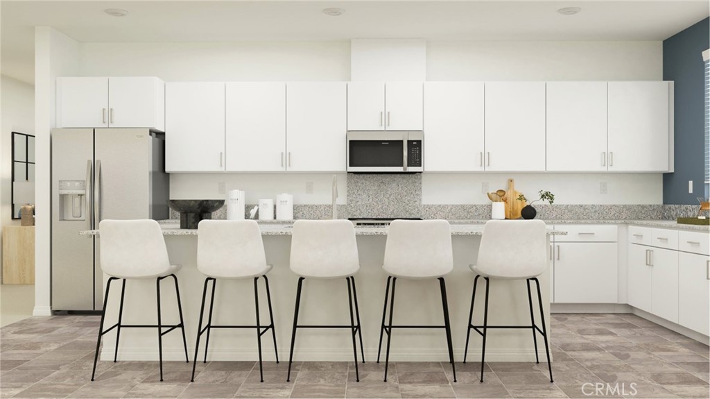 351 Deer Lane Way Perris, CA 92570 - Photo 3 of 15 a kitchen with stainless steel appliances granite countertop a table chairs microwave and sink