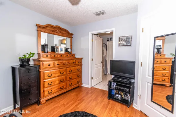 a bedroom with a bed and a television