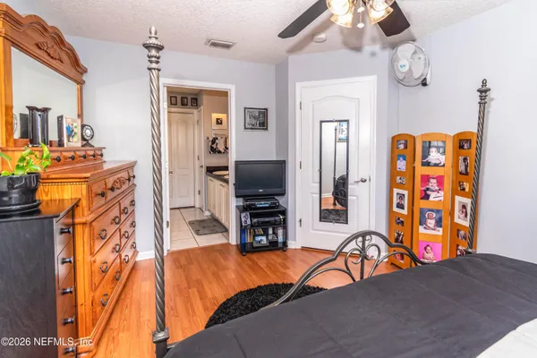 a living room with stainless steel appliances furniture and a flat screen tv