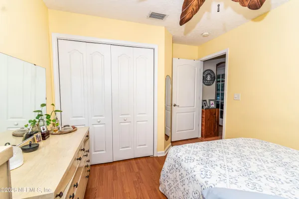 a bedroom with a bed and a dresser
