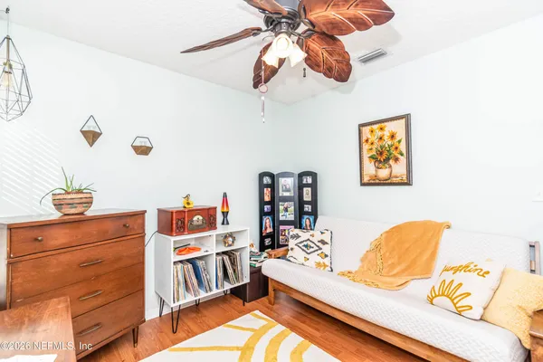 a bedroom with a bed and wooden floor