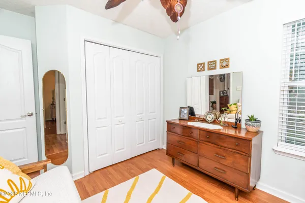 a room with a bed and a mirror