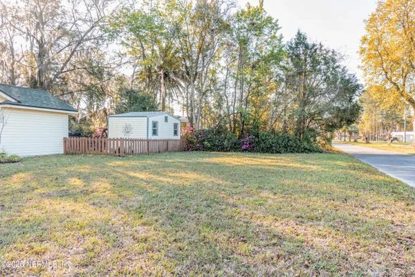 a view of a backyard with large trees