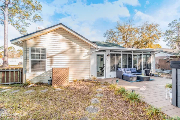 a view of a house with a patio and wooden fence