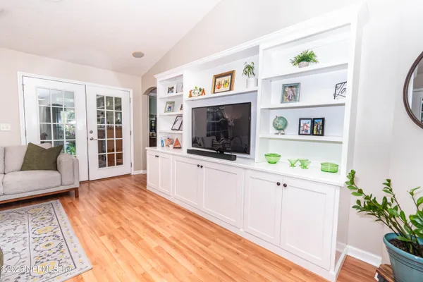 a living room with furniture and a flat screen tv
