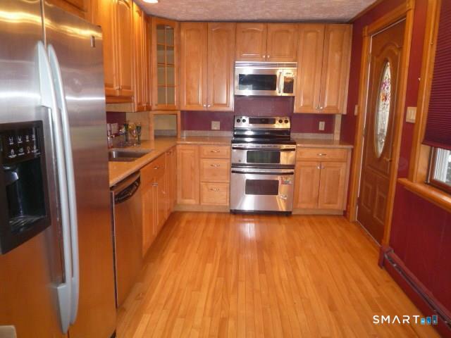 22 Broad Street Groton, CT 06340 - Photo 3 of 14 a kitchen with stainless steel appliances granite countertop a refrigerator a stove top oven a sink and dishwasher