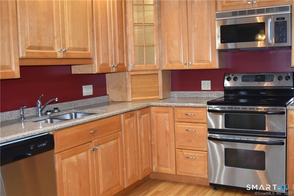 22 Broad Street Groton, CT 06340 - Photo 4 of 14 a kitchen with stainless steel appliances granite countertop a sink stove and microwave