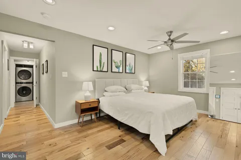 a bed sitting in a spacious bedroom next to a window